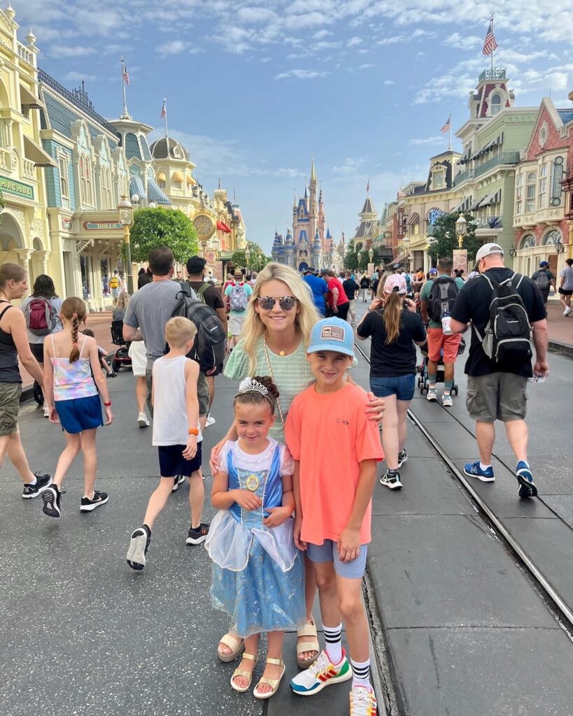 smiling in front of disney castle